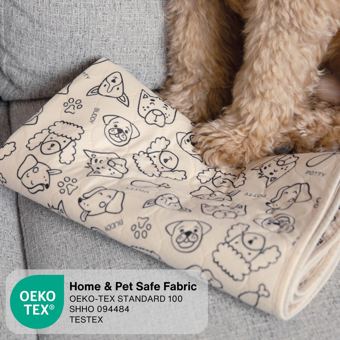 A beige pet blanket with black line drawings of various dog breeds and paw prints, shown on a gray sofa next to a small tan dog. An OEKO-TEX certification label is visible in the bottom left corner.