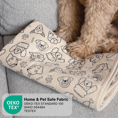 A beige pet blanket with black line drawings of various dog breeds and paw prints, shown on a gray sofa next to a small tan dog. An OEKO-TEX certification label is visible in the bottom left corner.